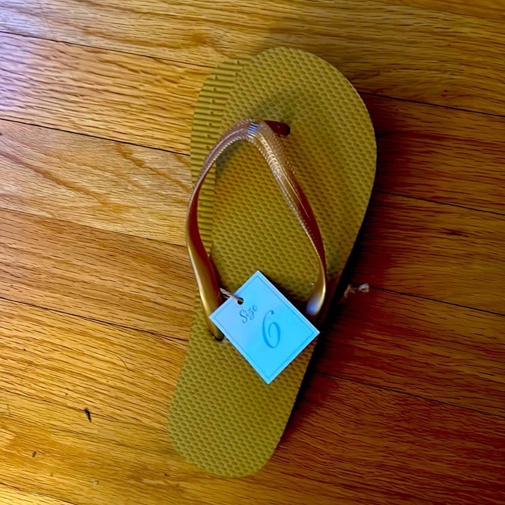 One pair of rich golden tannish flip flops